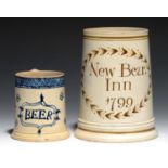 TWO PEARLWARE MUGS, ONE C1770, THE OTHER DATED 1799  the smaller painted in blue with a tablet
