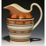 A SLIP BANDED AND ROULETTED MOCHA WARE JUG, C1820 with seaweed decoration, 19cm h Footrim chipped on