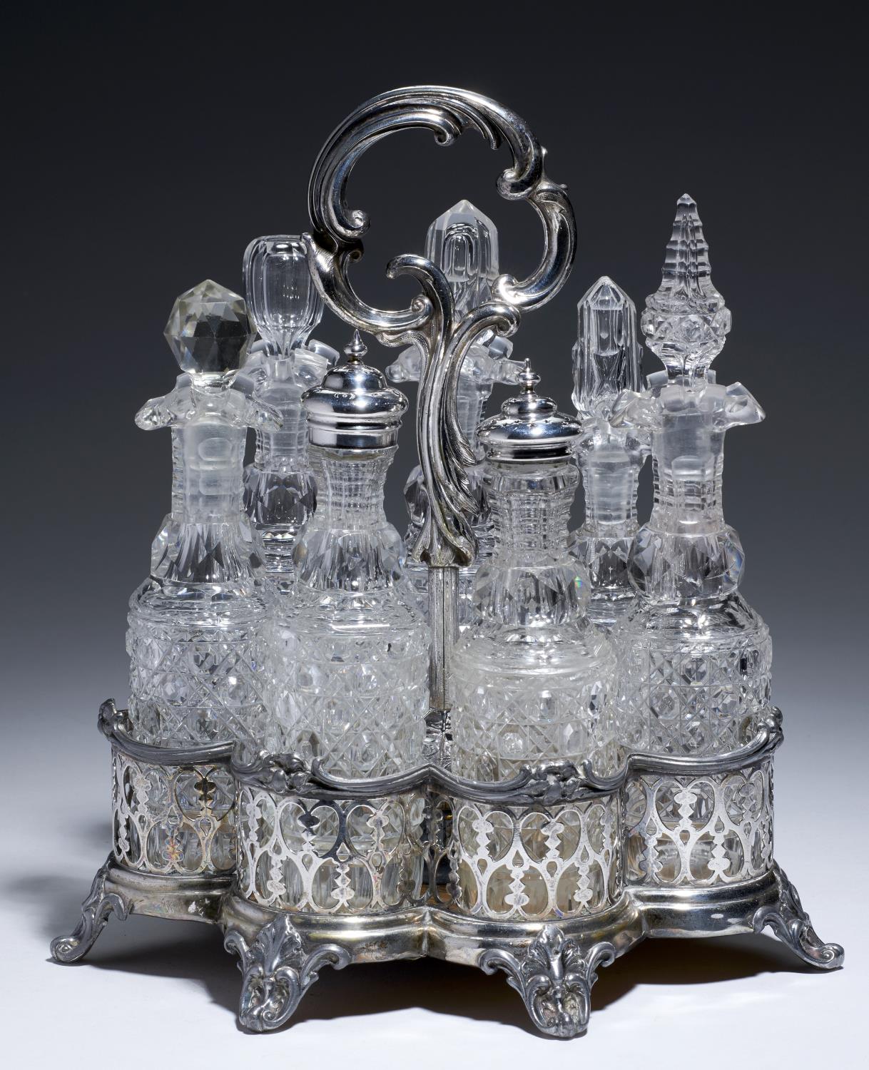 A VICTORIAN CUT GLASS SEVEN BOTTLE CRUET AND CONTEMPORARY PIERCED EPNS STAND, C1870  27cm h