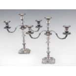 A PAIR OF ELIZABETH II SILVER CANDELABRA  of three lights on moulded square foot, nozzles, 36cm h,