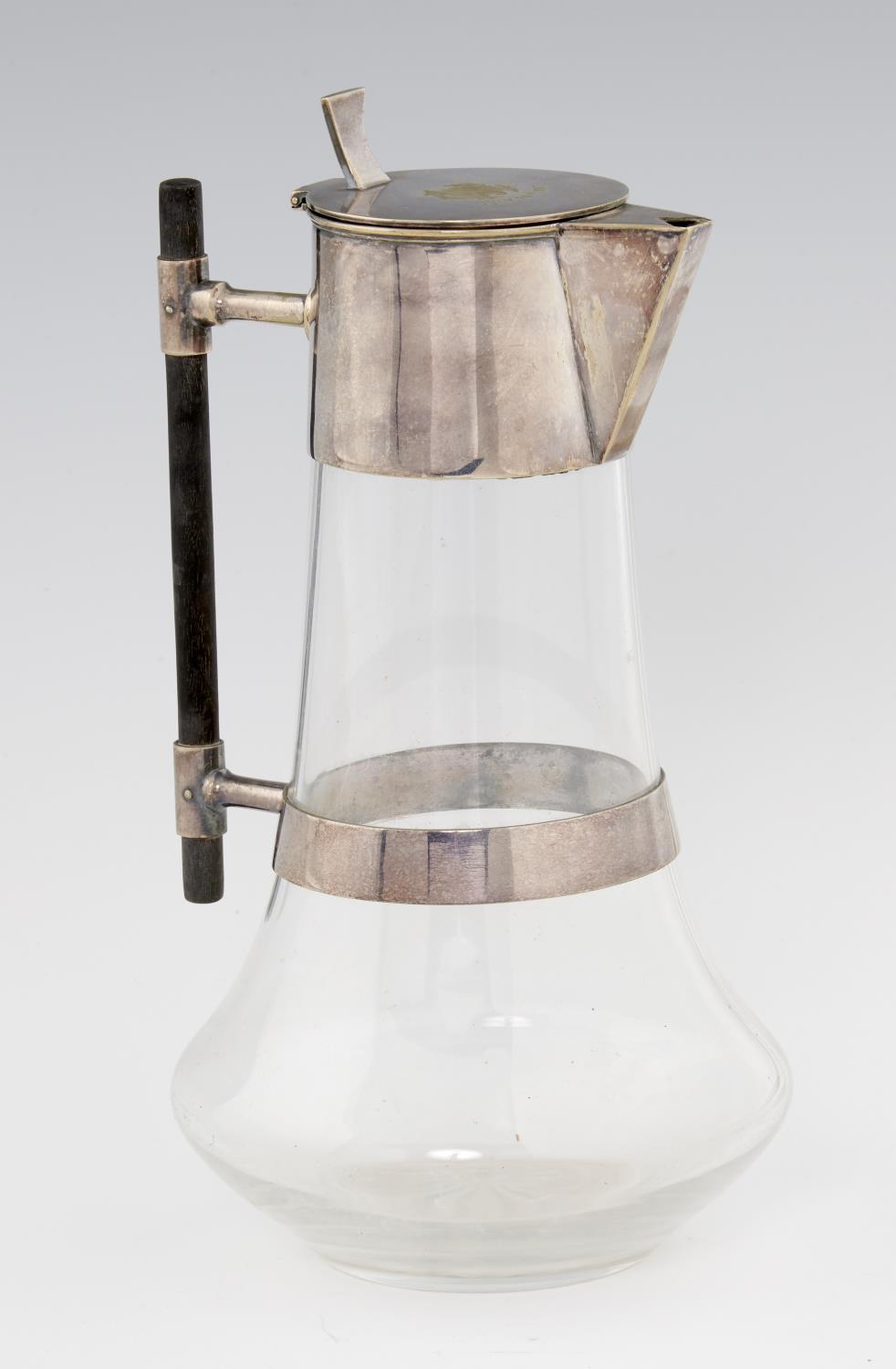 AN EPNS MOUNTED GLASS CLARET JUG BASED ON A DESIGN BY DR CHRISTOPHER DRESSER, DATED 1887 with rod