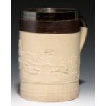 A TURNER BROWN DIPPED AND ENGINE TURNED FELSPATHIC STONEWARE HUNTING MUG, 1800   of half gallon