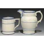 A MOULDED PEARLWARE WINCHESTER MEASURE AND SIMILAR JUG, C1830 half pint and pint respectively, the