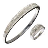 A DIAMOND BANGLE AND RING EN SUITE  with three rows of baguette and brilliant cut diamonds, in
