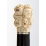 AN EBONY CANE WITH JAPANESE IVORY POMMEL, MEIJI PERIOD  the pommel carved with masks, ivory 4.