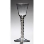 AN ENGLISH WINE GLASS, C1765  the bell bowl on double series opaque twist stem and conical foot,