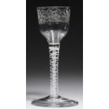 AN ENGLISH WINE GLASS, C1770 the ogee bowl engraved with trailing flowers, on double series opaque