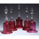 FIVE VICTORIAN CRANBERRY GLASS BELLS, MID 19TH C  with clear spiral handle, 30-34cm h, all but one