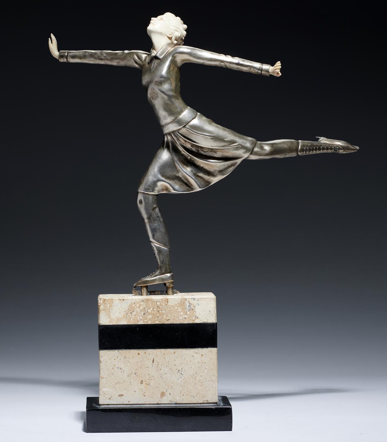 AN ART DECO SILVERED METAL AND IMITATION IVORY STATUETTE OF A FEMALE ICE SKATER, C1930   limestone