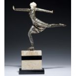 AN ART DECO SILVERED METAL AND IMITATION IVORY STATUETTE OF A FEMALE ICE SKATER, C1930   limestone