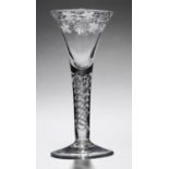 AN ENGLISH WINE GLASS, C1750   the drawn trumpet bowl engraved with grapevines on 'mercury' twist