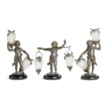 A SET OF THREE FRENCH FIN DE SIECLE BRONZED SPELTER AND GLASS FLOWER STANDS IN THE FORM OF PUTTI,