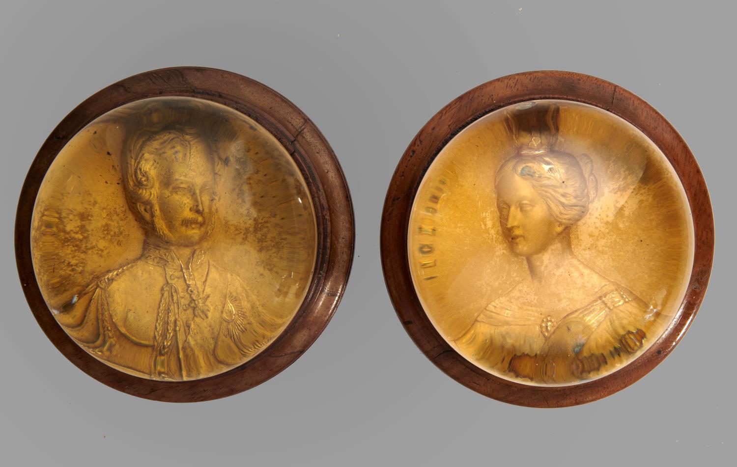 A PAIR OF ENGLISH ROYAL COMMEMORATIVE GLASS PINCHBECK PAPERWEIGHTS, C1840  with matt gilt relief