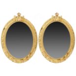 A PAIR OF OVAL GILTWOOD MIRRORS, EARLY 20TH C crested by the Royal Arms of France and applied with