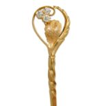 A CHINESE GOLD STICKPIN  the spirally fluted shaft terminating in a leaf set with three diamonds,