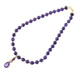AN AMETHYST AND DIAMOND PENDANT ON A NECKLACE OF AMETHYST BEADS  with larger pear shaped