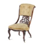 A VICTORIAN CARVED WALNUT NURSING CHAIR, C1870 on pottery castors, 87cm h Ornate pierced splat and