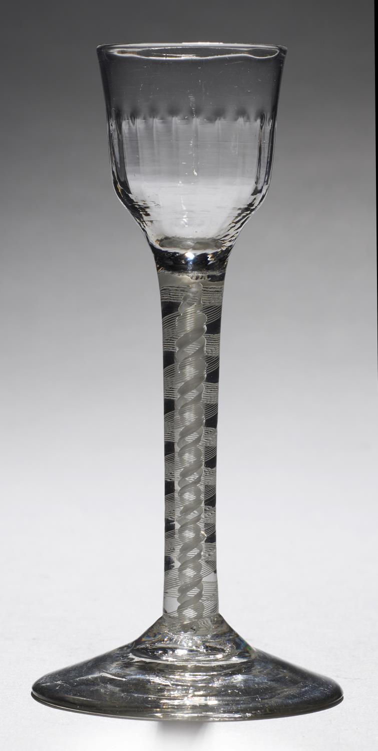 AN ENGLISH CORDIAL GLASS, C1770  the moulded ogee bowl on double series opaque twist stem, conical