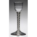 AN ENGLISH CORDIAL GLASS, C1770  the moulded ogee bowl on double series opaque twist stem, conical