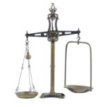 A SET OF ORNATE CAST IRON AND BRASS WEIGHING SCALES, EARLY 20TH C  with brass pans, 111cm h Complete