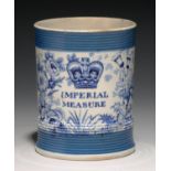 A BLUE PRINTED EARTHENWARE IMPERIAL MEASURE, C1840  half pint, with reeded blue bands, 9cm h Good