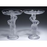 A PAIR OF JOHN FORD OF EDINBURGH MAN AND WOMAN FIGURAL MOULDED GLASS STANDS OR CANDLESTICKS AND PAIR