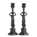 A PAIR OF NEO-CLASSICAL STYLE BRONZE FIGURAL CANDLESTICKS, EARLY-MID 19TH C  on milled drum base,