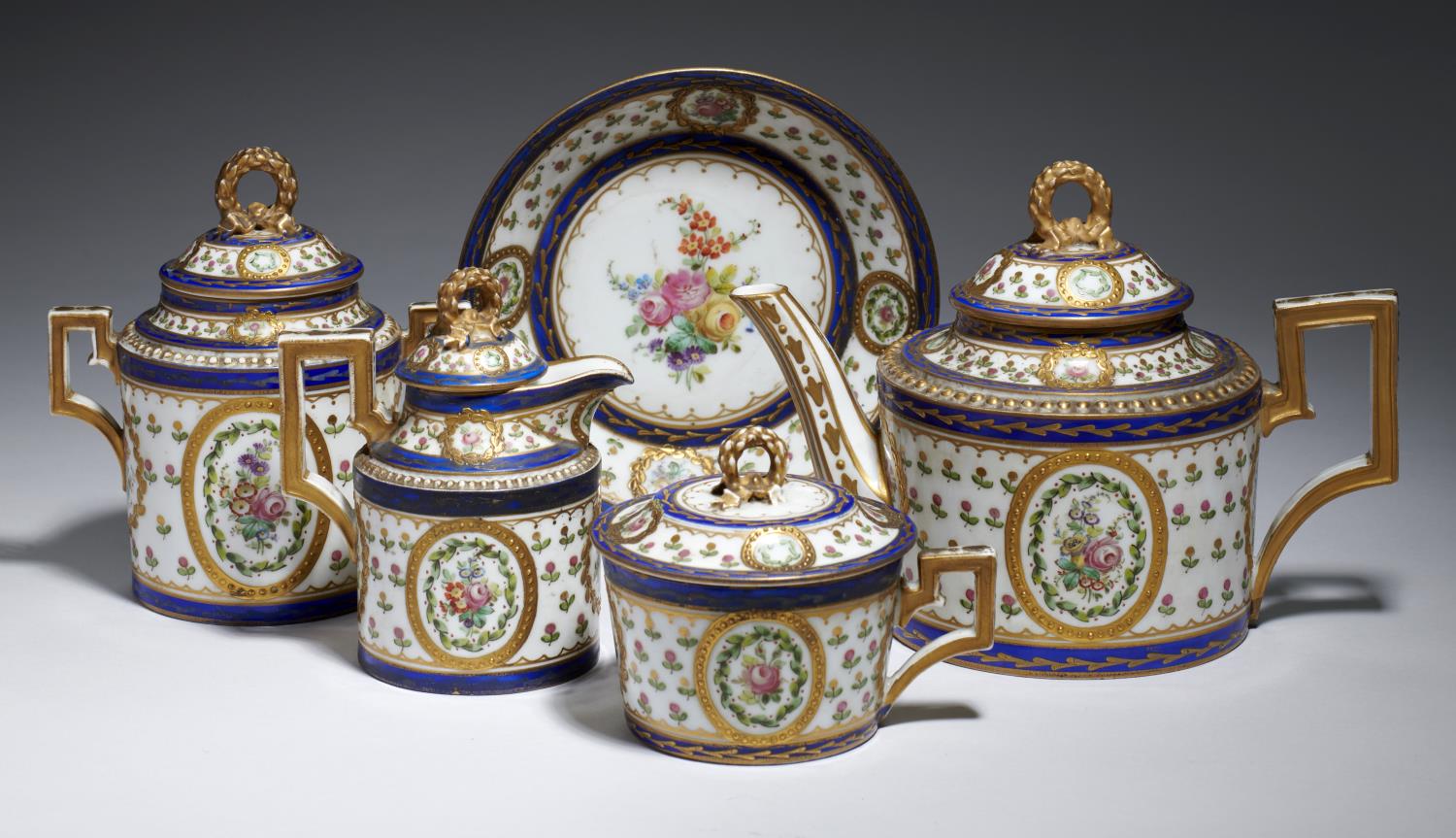 A FRENCH PORCELAIN CABARET SET, C1900 each piece of cylindrical form and painted with flowers