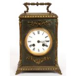 A CONTINENTAL BRASS MOUNTED AND LEATHER COVERED MANTEL CLOCK WITH ENAMEL DIAL AND BREGUET HANDS,