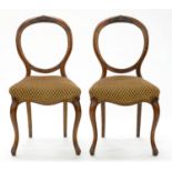 A PAIR OF VICTORIAN CARVED WALNUT BALLOON BACK DINING CHAIRS