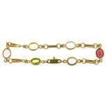 A GOLD BRACELET, MARKED 750, SPECTACLE SET WITH AMETHYST, GARNET, PERIDOT, AQUAMARINE AND CITRINE,