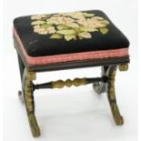 A REGENCY STYLE BLACK AND GOLD PAINTED PAINTED X FRAME STOOL WITH WOOLWORK TOP, 44CM X 44CM W