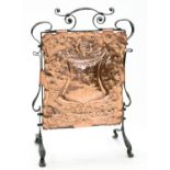AN ARTS AND CRAFTS COPPER AND WROUGHT IRON FIRESCREEN WITH EMBOSSED PANEL, 82CM H X 56CM W, EARLY
