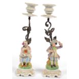 A PAIR OF CONTINENTAL METAL MOUNTED PAINTED BISCUIT PORCELAIN BOY AND GIRL FIGURAL CANDLESTICKS,