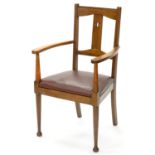 AN ARTS & CRAFTS WALNUT ELBOW CHAIR, EARLY 20TH C