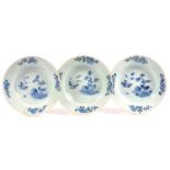 A SET OF THREE CHINESE BLUE AND WHITE SOUP PLATES PAINTED WITH HUT AND ISLANDS, FOUR FLORAL BORDER