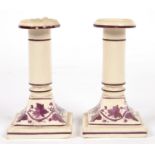 A PAIR OF ENGLISH FELSPATHIC STONEWARE DWARF CANDLESTICKS, PAINTED IN PURPLE MONOCHROME WITH