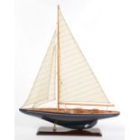 A FINELY DETAILED VARNISHED WOOD AND PAINTED MODEL OF A YACHT WITH MAST, RIGGING AND SAILS