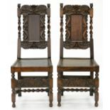 A PAIR OF CHARLES II STYLE CARVED OAK CHAIRS WITH BORDERED SEATS