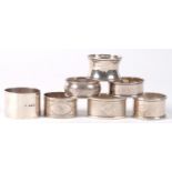 SEVEN SILVER NAPKIN RINGS, GEORGE V AND LATER, 7OZS