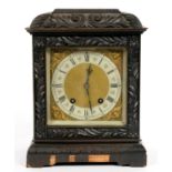 A CARVED AND DARK STAINED OAK MANTEL CLOCK WITH LENZKIRCH TING TANG MOVEMENT, 32CM H, LATE 19TH C