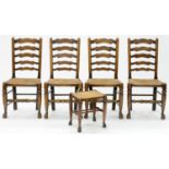 A SET OF FOUR OAK RUSH SEATED LADDER BACK DINING CHAIRS, EARLY 20TH C AND A STOOL