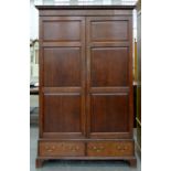A CHANNEL ISLANDS OAK AND MAHOGANY CROSSBANDED WARDROBE WITH PANELLED DOORS AND DENTIL CORNICE,