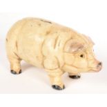 A PAINTED CAST IRON GLASS EYED PIG NOVELTY BANK, 25CM L
