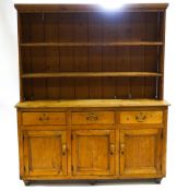 A Victorian pine dresser with two shelf plain plank back under a plain cornice,
