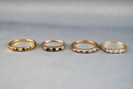 A collection of rings to include: A hallmarked 9ct gold ruby and diamond half hoop ring;