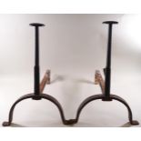 A pair of wrought iron fire dogs,