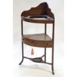 A George III mahogany bow fronted corner wash stand with one frieze drawer, overall 100cm high,