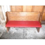 A oak pew with single panelled back and prayer book shelf to the reverse,134cm wide, 40cm deep,