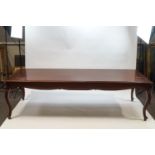 A large French style mahogany dining table with shaped apron on cabriole legs,